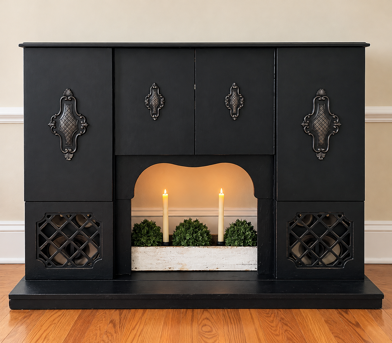 Black decorative fireplace with ornate hardware and a candle display