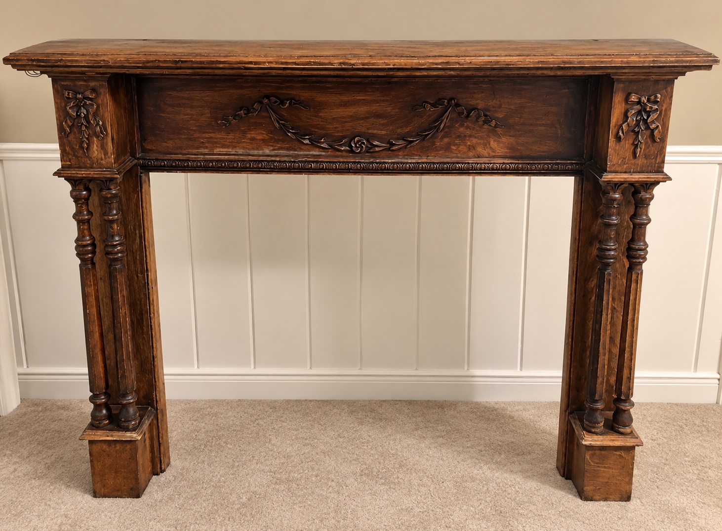 Ornate dark wood fireplace mantel before refinishing